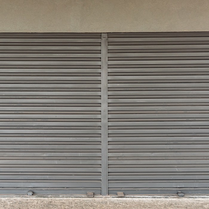 Damaged garage door roller being replaced to improve smooth operation