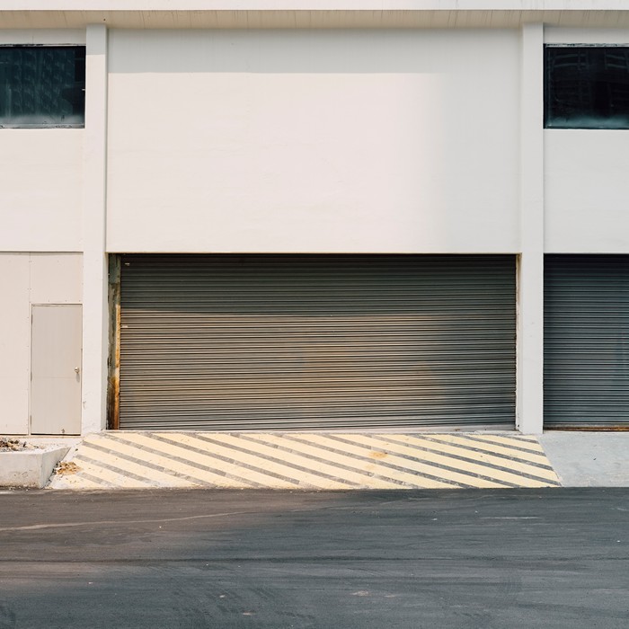 Eagle Garage Door technician troubleshooting a malfunctioning garage door remote